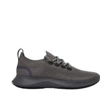 Profile view of a single charcoal grey Allbirds Tree Dasher 2 sneaker, showcasing its breathable knit upper, patterned laces, and thick dark grey midsole.