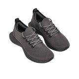 Three-quarter perspective of a pair of charcoal grey Allbirds Tree Dasher 2 shoes, highlighting the textured knit upper, matching laces, and sock-like collar.