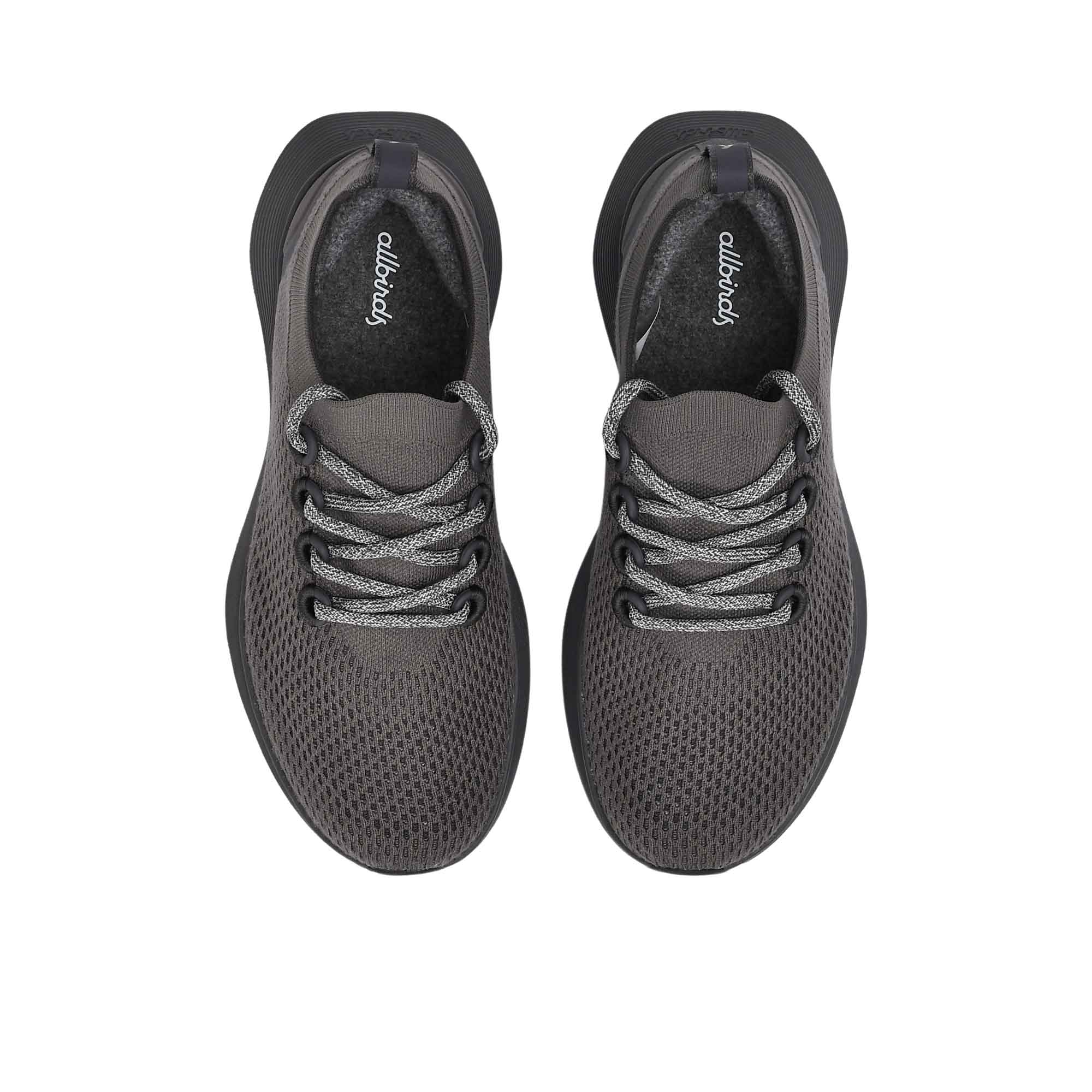 Top-down overhead view of the sneakers displaying the matching dark insoles printed with the white Allbirds logo.