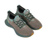 Full view of the natural rubber outsole, featuring a light pink forefoot tread and a dark grey heel tread separated by a white central foam channel.