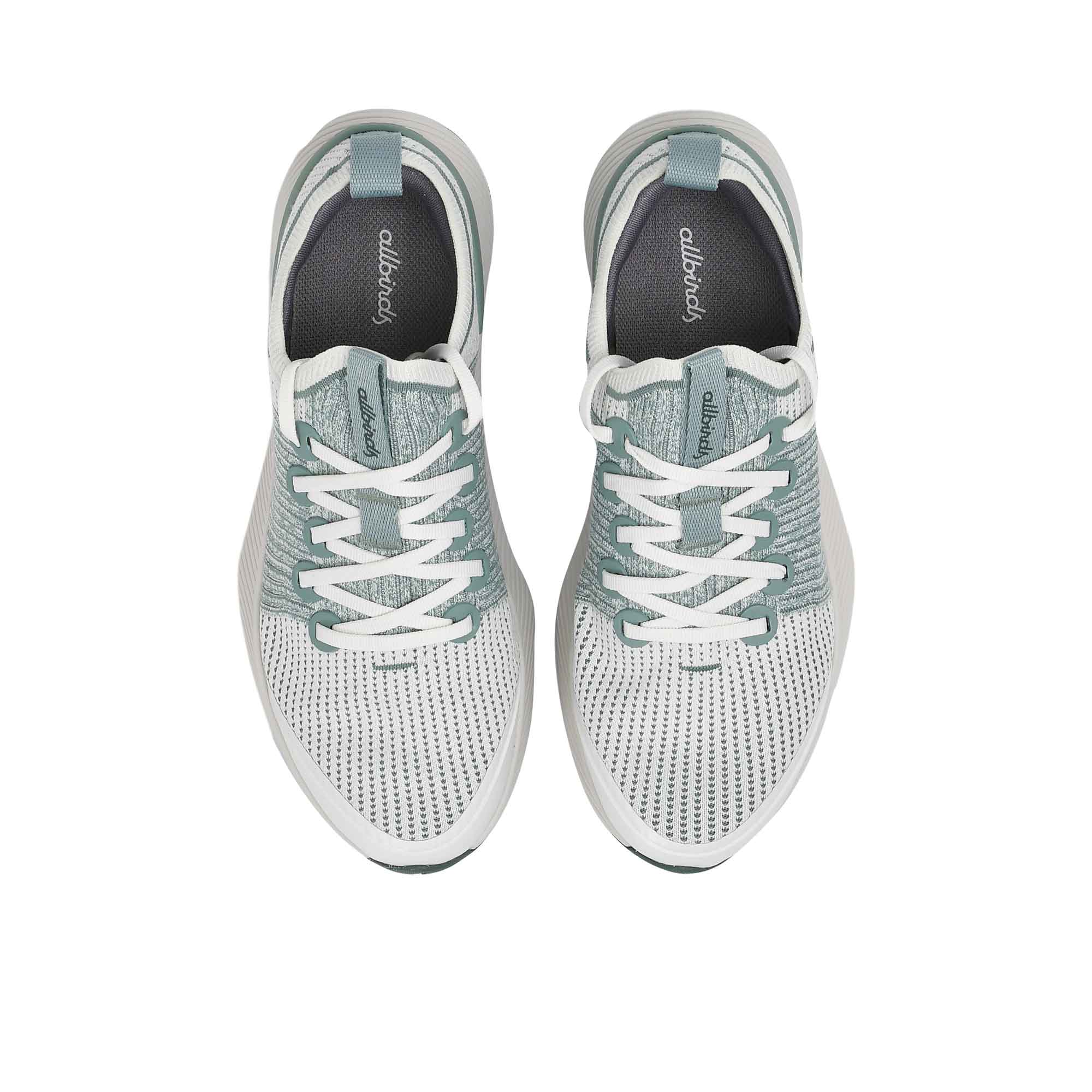 Full view of the textured, dark sage green natural rubber outsole of the Allbirds shoe, showcasing the traction pattern and central foam channel.