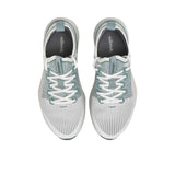 Full view of the textured, dark sage green natural rubber outsole of the Allbirds shoe, showcasing the traction pattern and central foam channel.