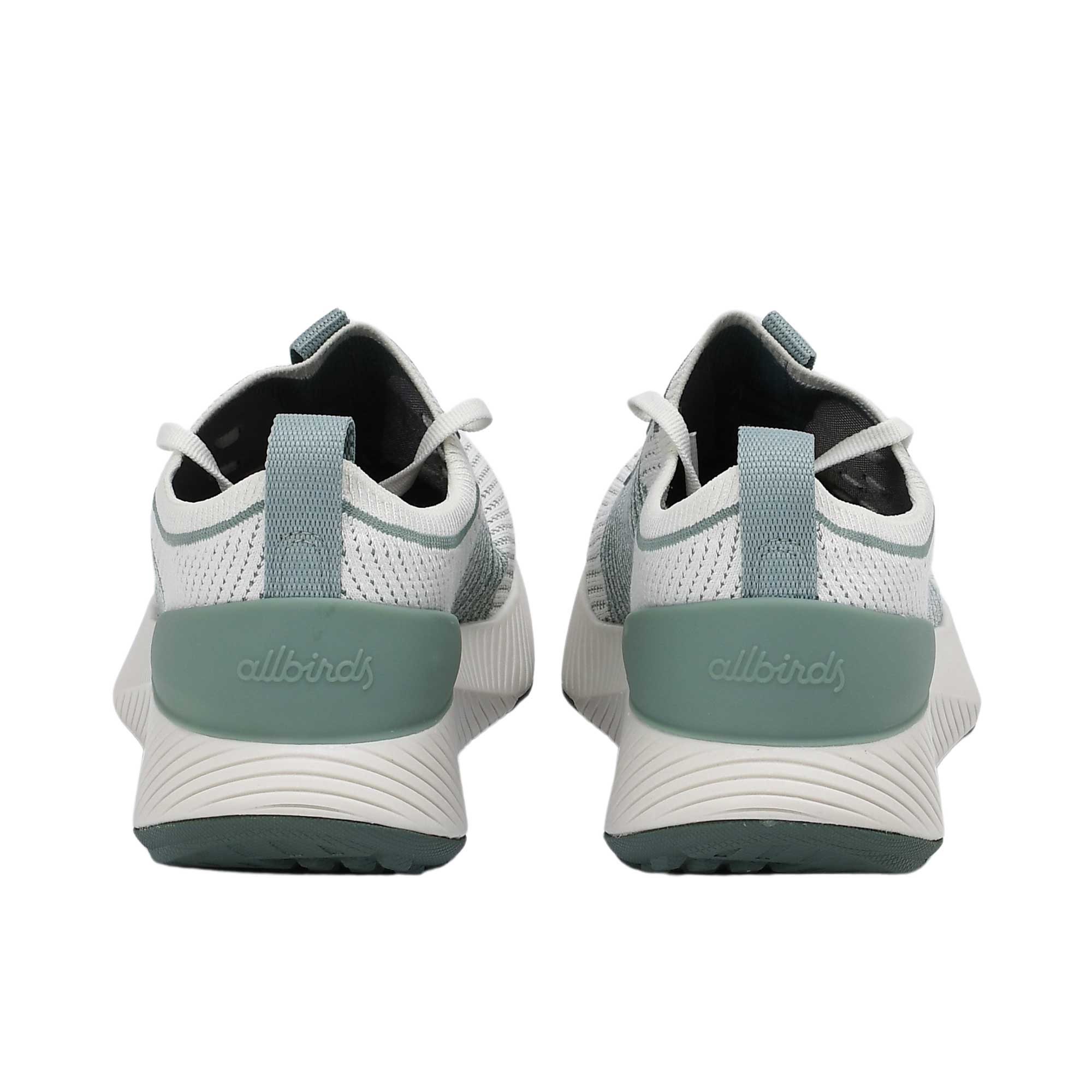 Elevated three-quarter perspective of a pair of Allbirds Tree Flyer sneakers showcasing the textured knit pattern, white laces, and sage green detailing.