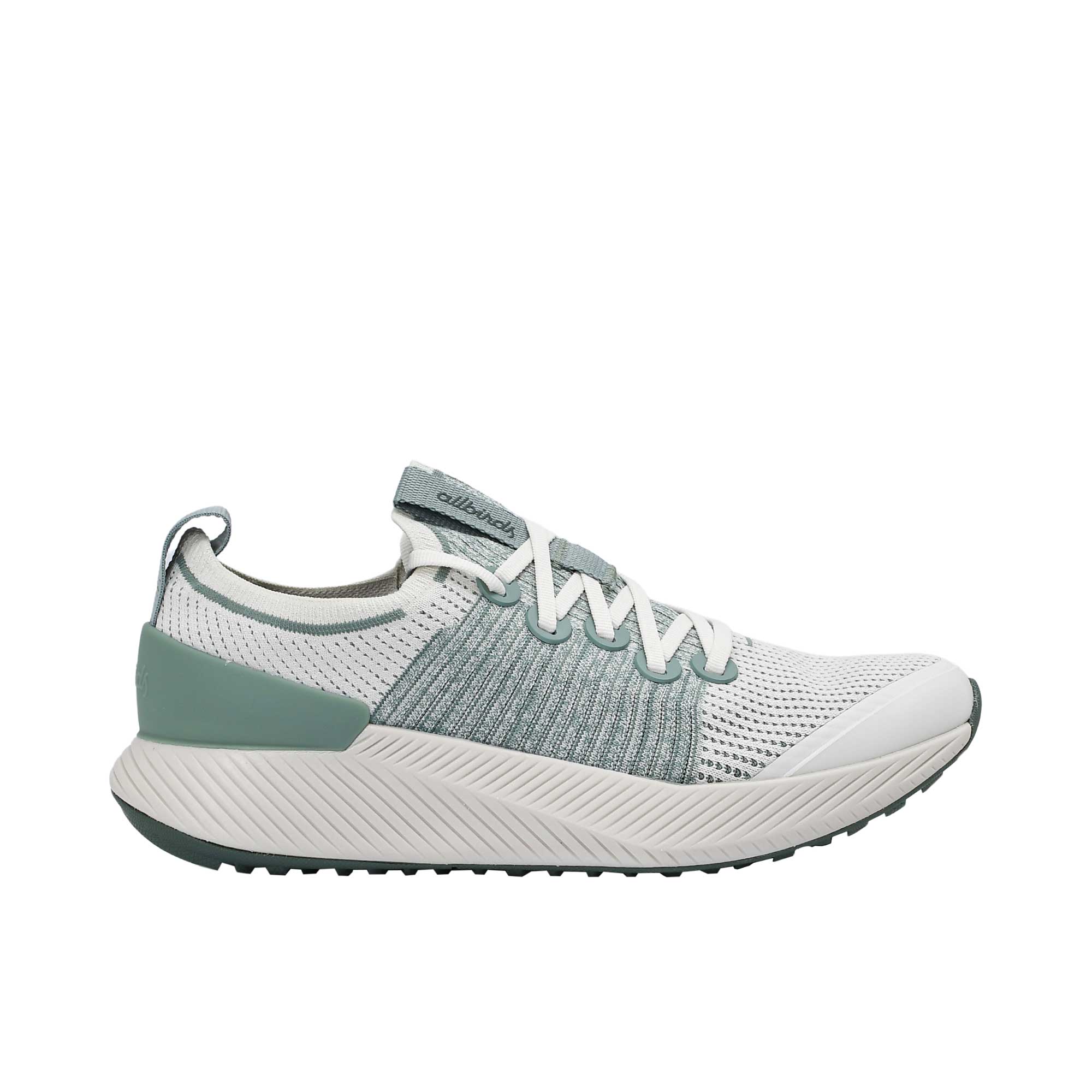 Profile view of a single Allbirds Tree Flyer running shoe featuring a white knit upper, sage green midfoot and heel accents, and a thick, textured off-white midsole.