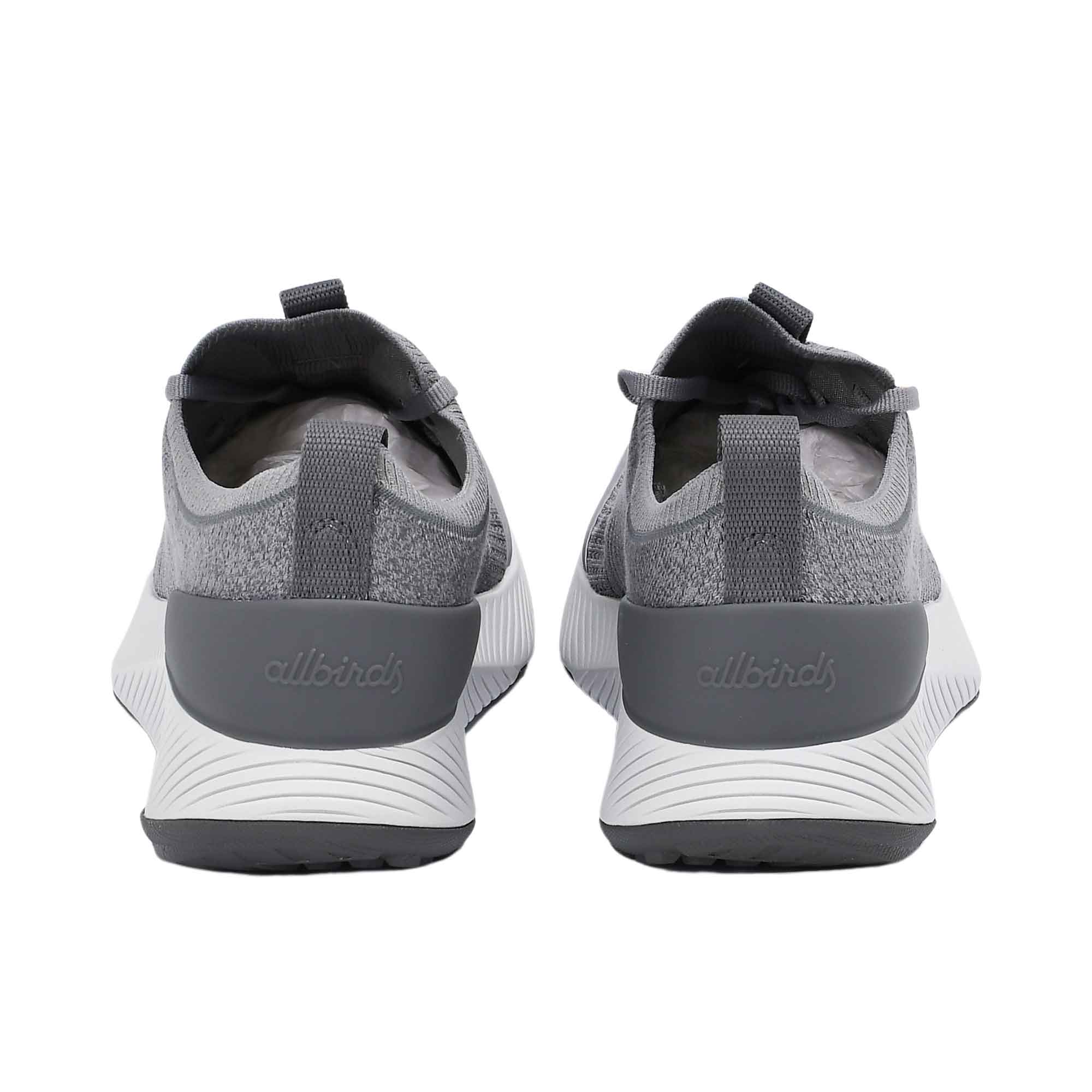 Back view of a pair of Allbirds Tree Flyer 2 shoes showing the grey external heel counters with the embossed Allbirds logo.