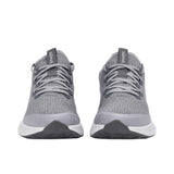 Gray athletic shoes with white soles on a white background.
