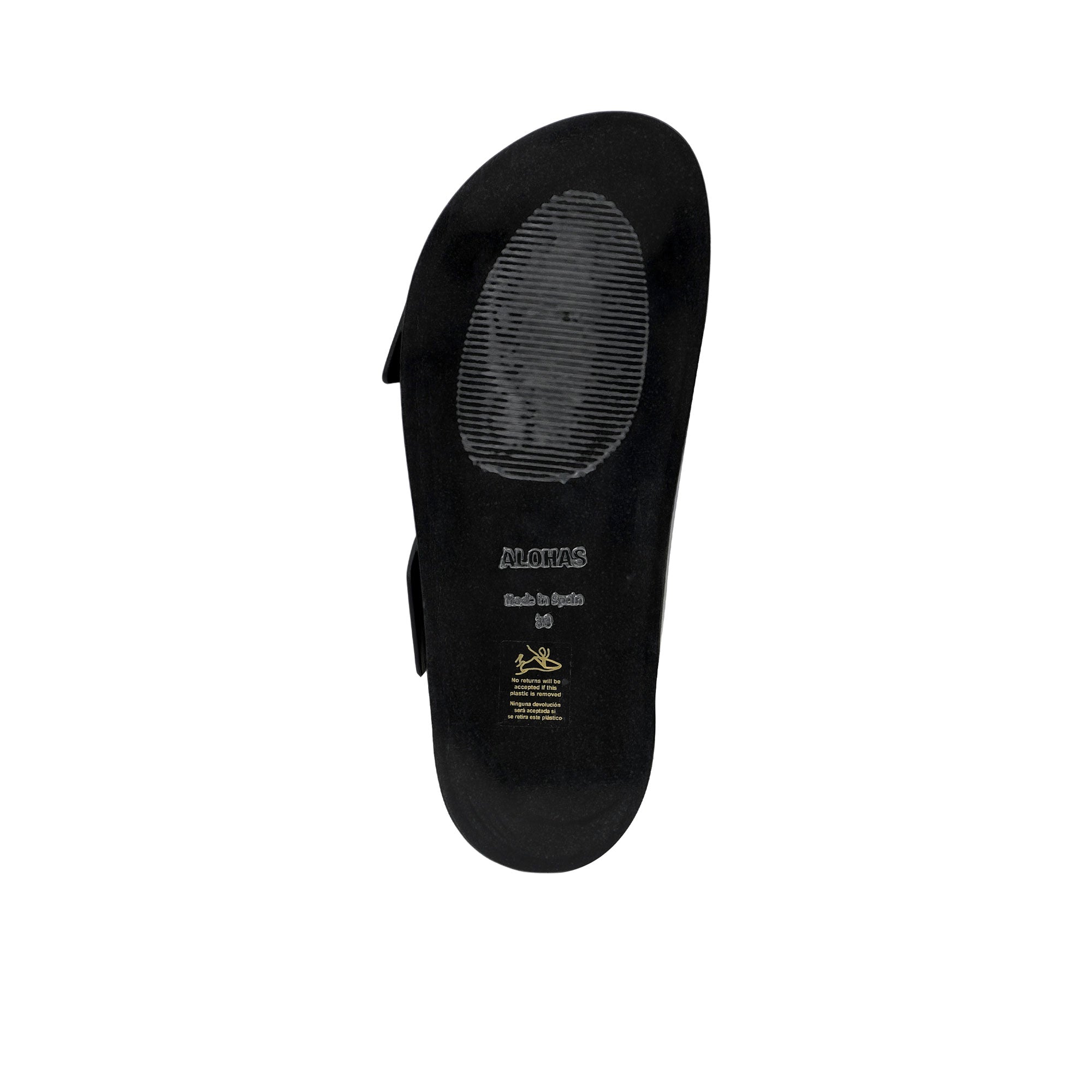 Bottom view of the black outsole of an ALOHAS sandal, showing the debossed logo, "Made in Spain" inscription, size 38 stamp, and a textured grip pad.