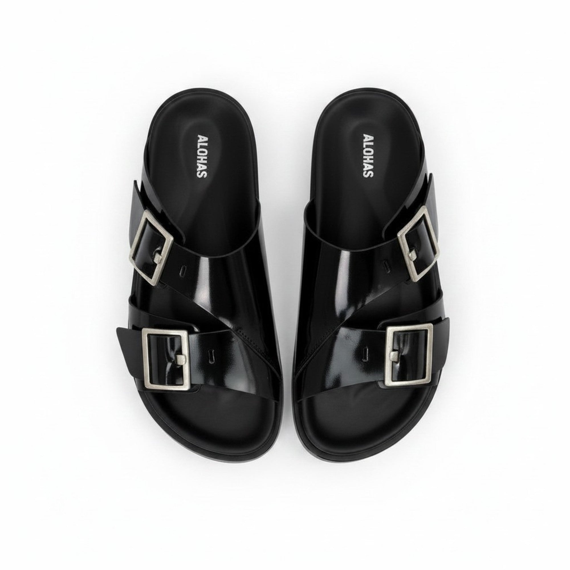 Top-down bird's-eye view of a pair of black ALOHAS slide sandals with dual adjustable buckled straps and contoured footbeds.