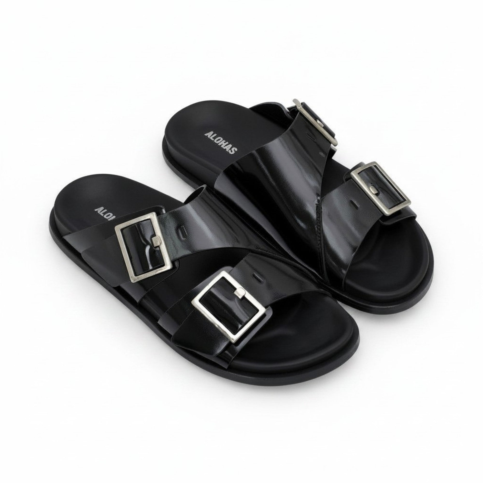 Oblique overhead view of a pair of ALOHAS black double-strap buckled sandals displaying the white ALOHAS branding printed on the insoles.