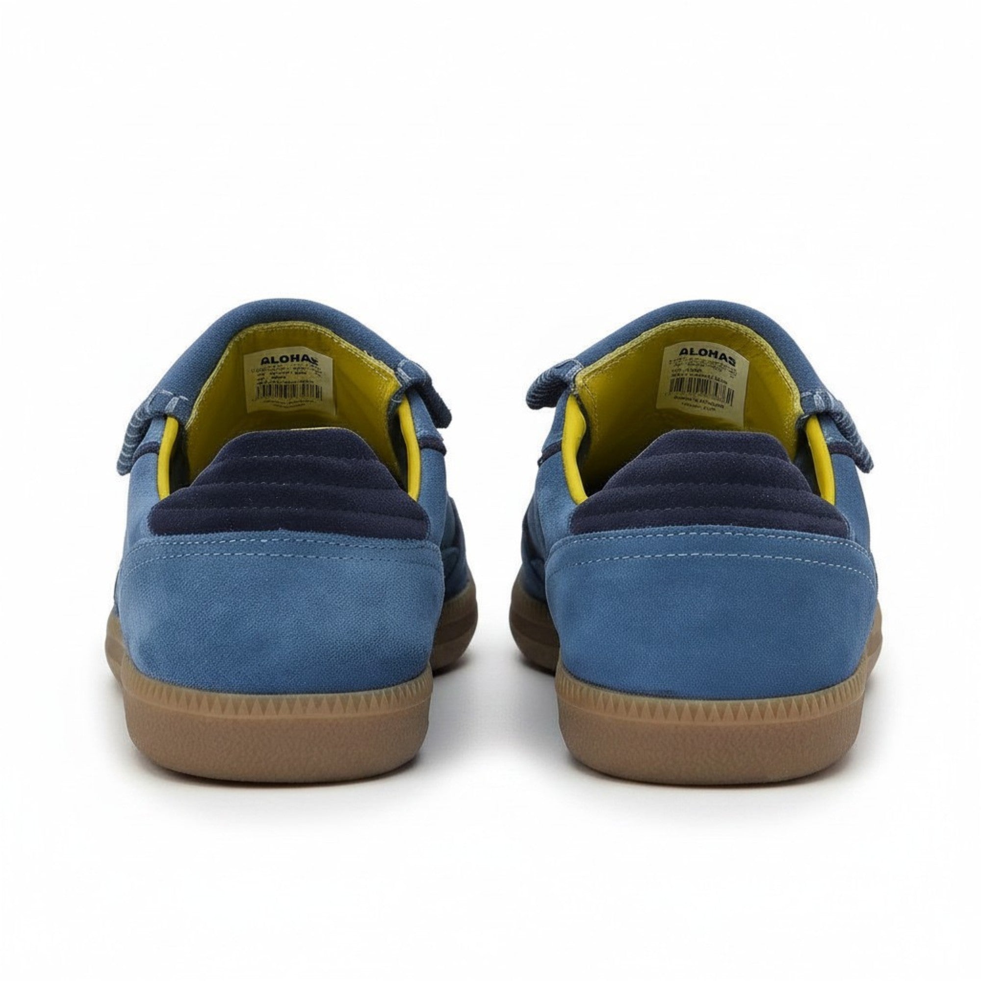 Rear view of the sneakers, showing the textured brown gum soles, blue suede heels with ribbed navy blue trim, and a highly visible bright yellow interior lining.