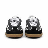 Black and white sneakers with brown soles on a white background.