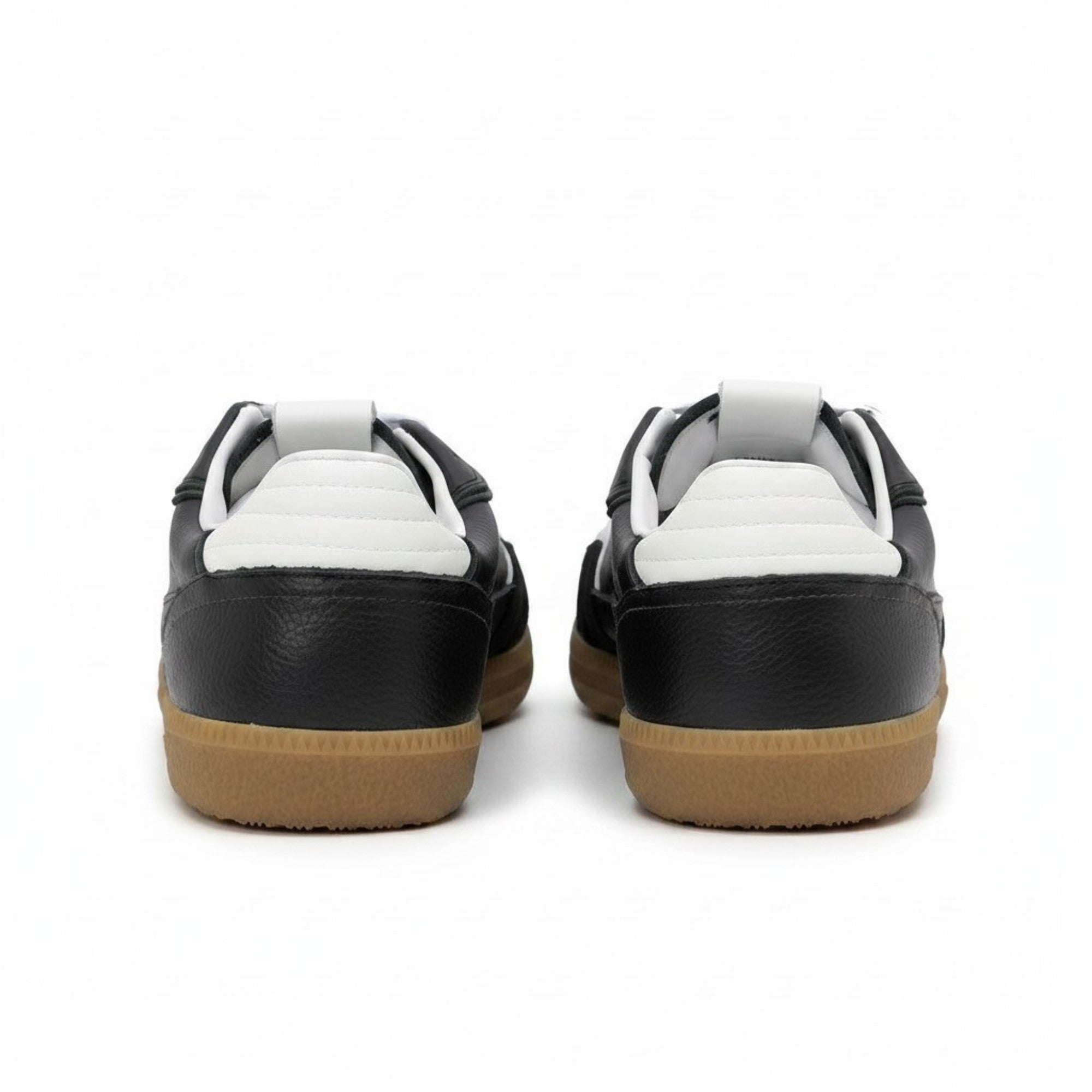 Black sneakers with white soles and brown soles on a white background.