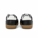 Black sneakers with white soles and brown soles on a white background.