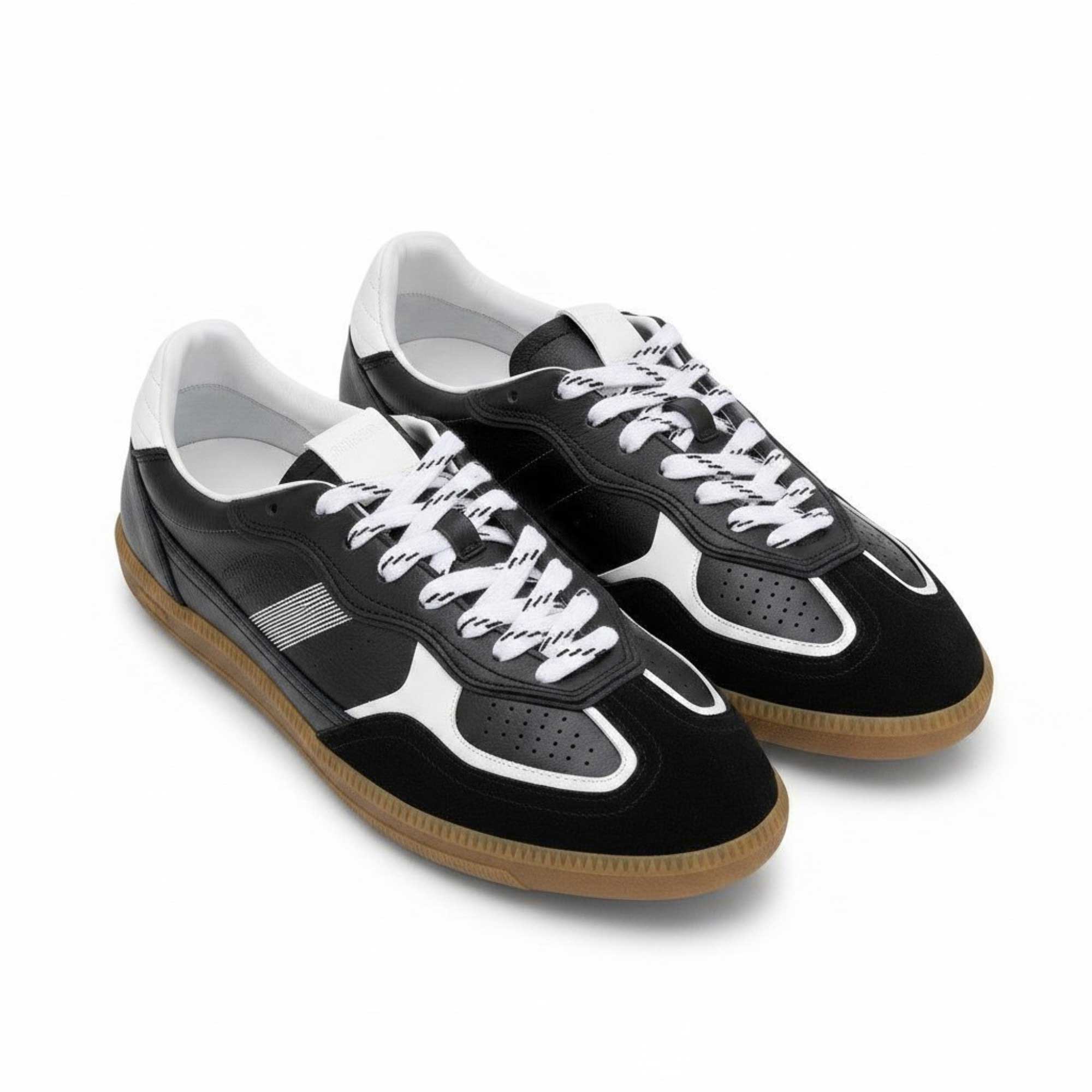 Black and white sneakers with brown soles on a white background.