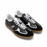 Black and white sneakers with brown soles on a white background.