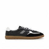 Black sneaker with white accents on a white background.