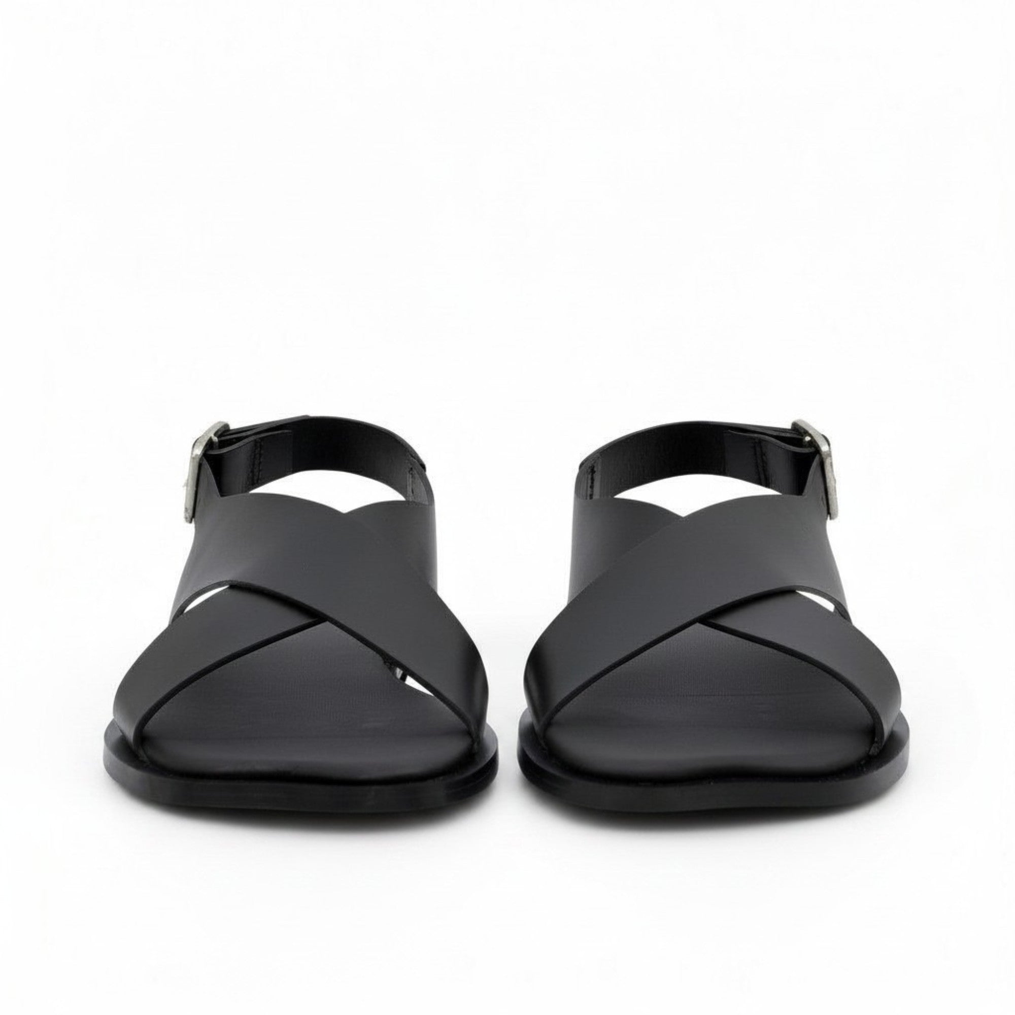 Front view of a pair of ALOHAS beige sandals showing the wide crossover asymmetric straps with fine dark piping.