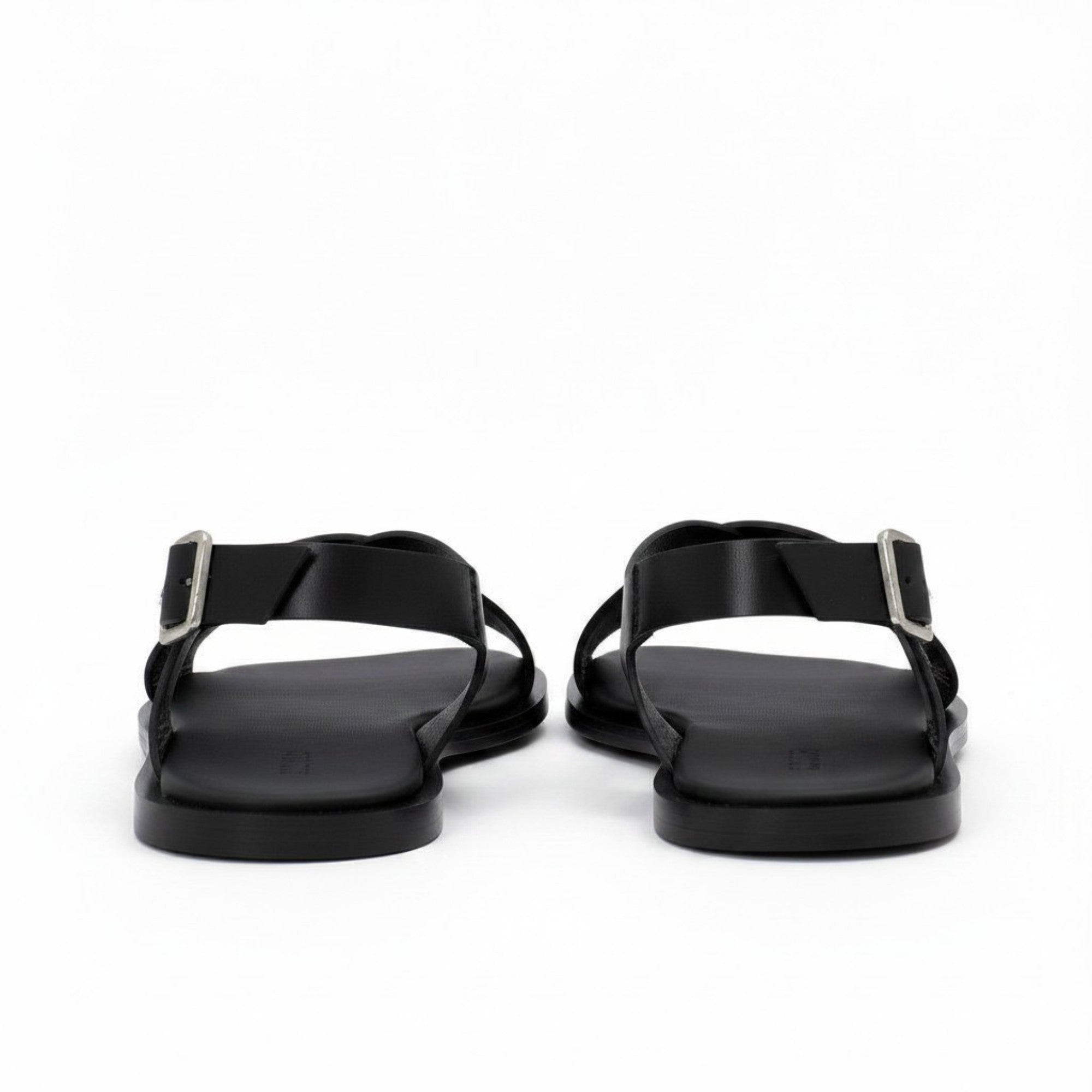 Rear heel view of a pair of ALOHAS beige slingback sandals highlighting the adjustable ankle straps and flat black soles.