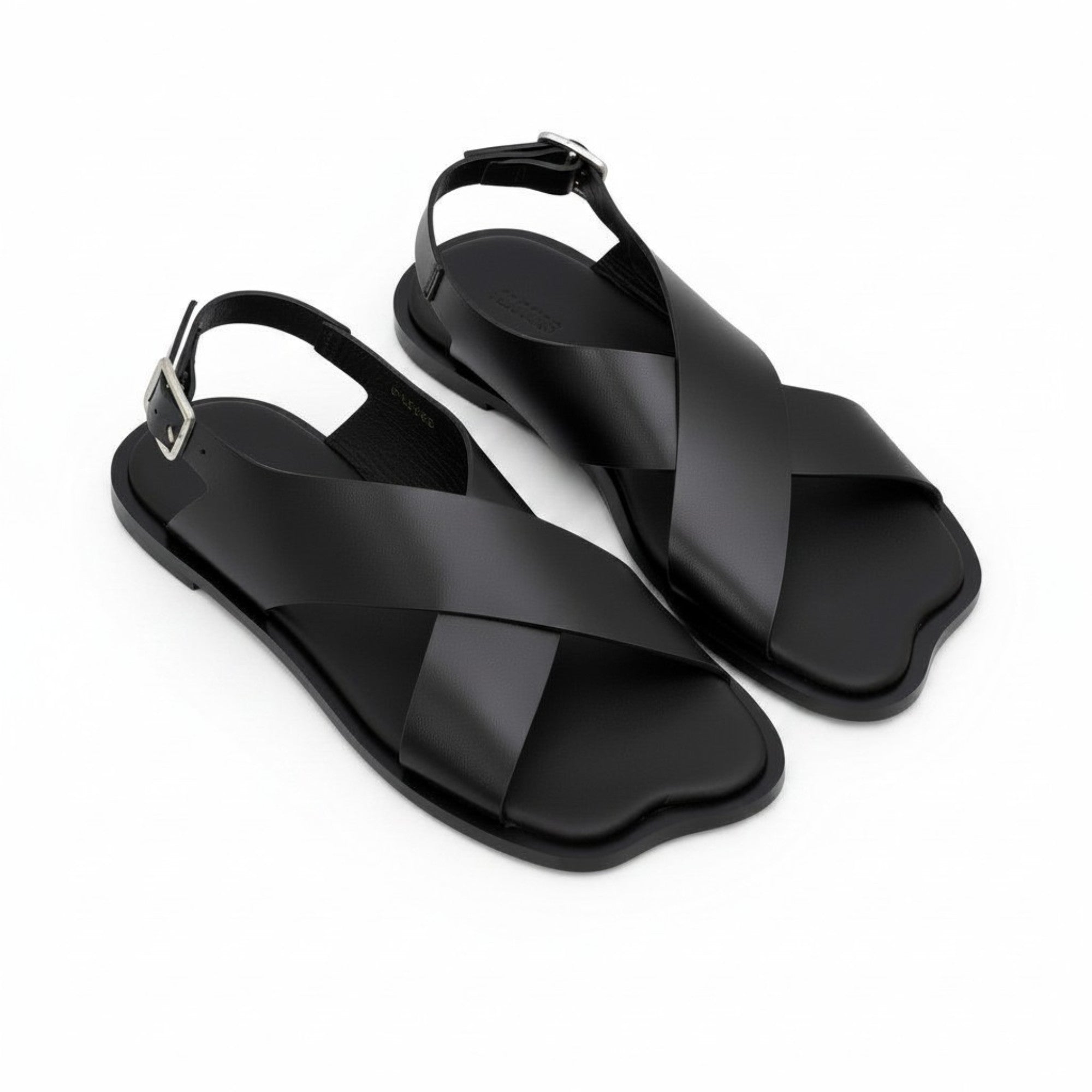 Oblique overhead view of a pair of ALOHAS beige crossover sandals showcasing the unique contoured shape of the toe box and subtle footbed branding.