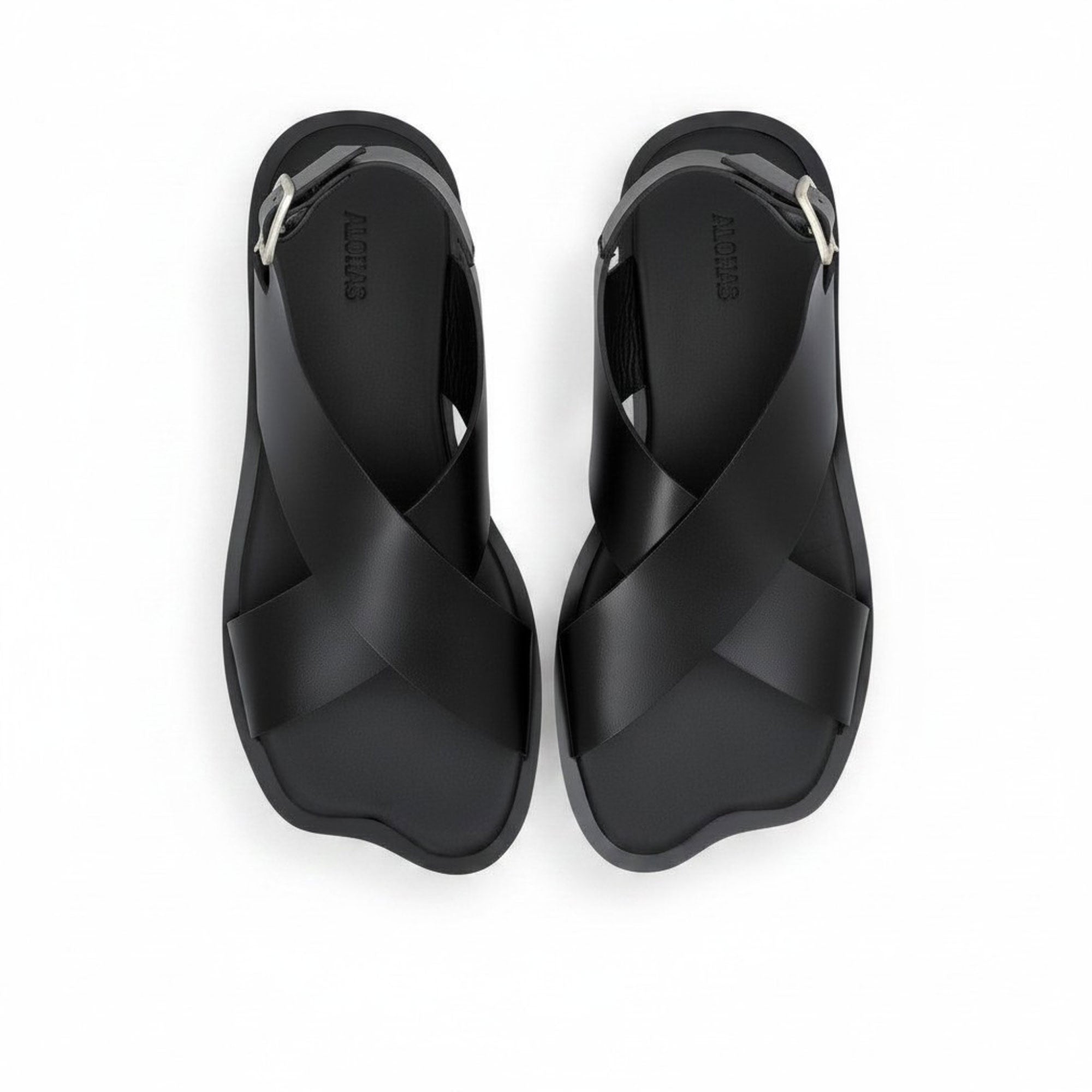 Top-down bird's-eye view of a pair of ALOHAS beige asymmetric strap sandals with printed logos on the insoles.