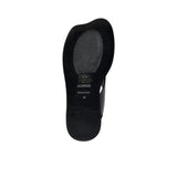 Bottom view of the black outsole of an ALOHAS sandal, featuring the debossed brand name, "Made in Spain" , stamp, and a textured non-slip pad.