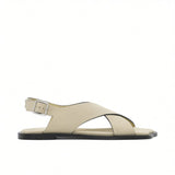 Side profile view of a single ALOHAS beige crossover slingback sandal with a silver-tone buckle and flat black sole against a white background.