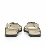 Rear heel view of a pair of ALOHAS beige slingback sandals highlighting the adjustable ankle straps and flat black soles.