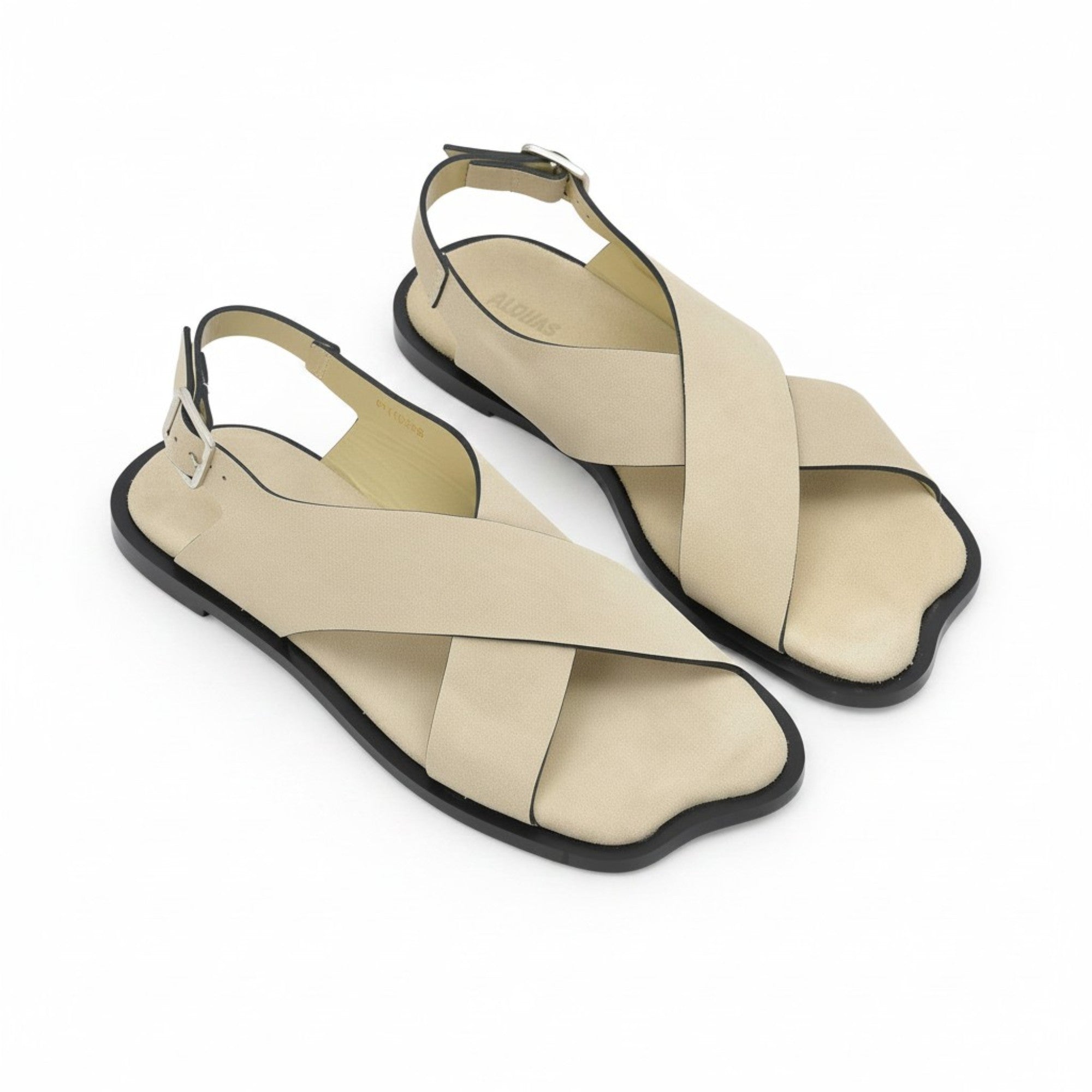 Oblique overhead view of a pair of ALOHAS beige crossover sandals showcasing the unique contoured shape of the toe box and subtle footbed branding.