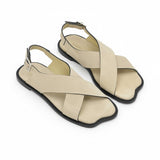 Oblique overhead view of a pair of ALOHAS beige crossover sandals showcasing the unique contoured shape of the toe box and subtle footbed branding.