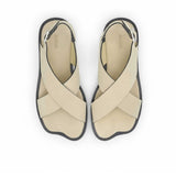 Top-down bird's-eye view of a pair of ALOHAS beige asymmetric strap sandals with printed logos on the insoles.