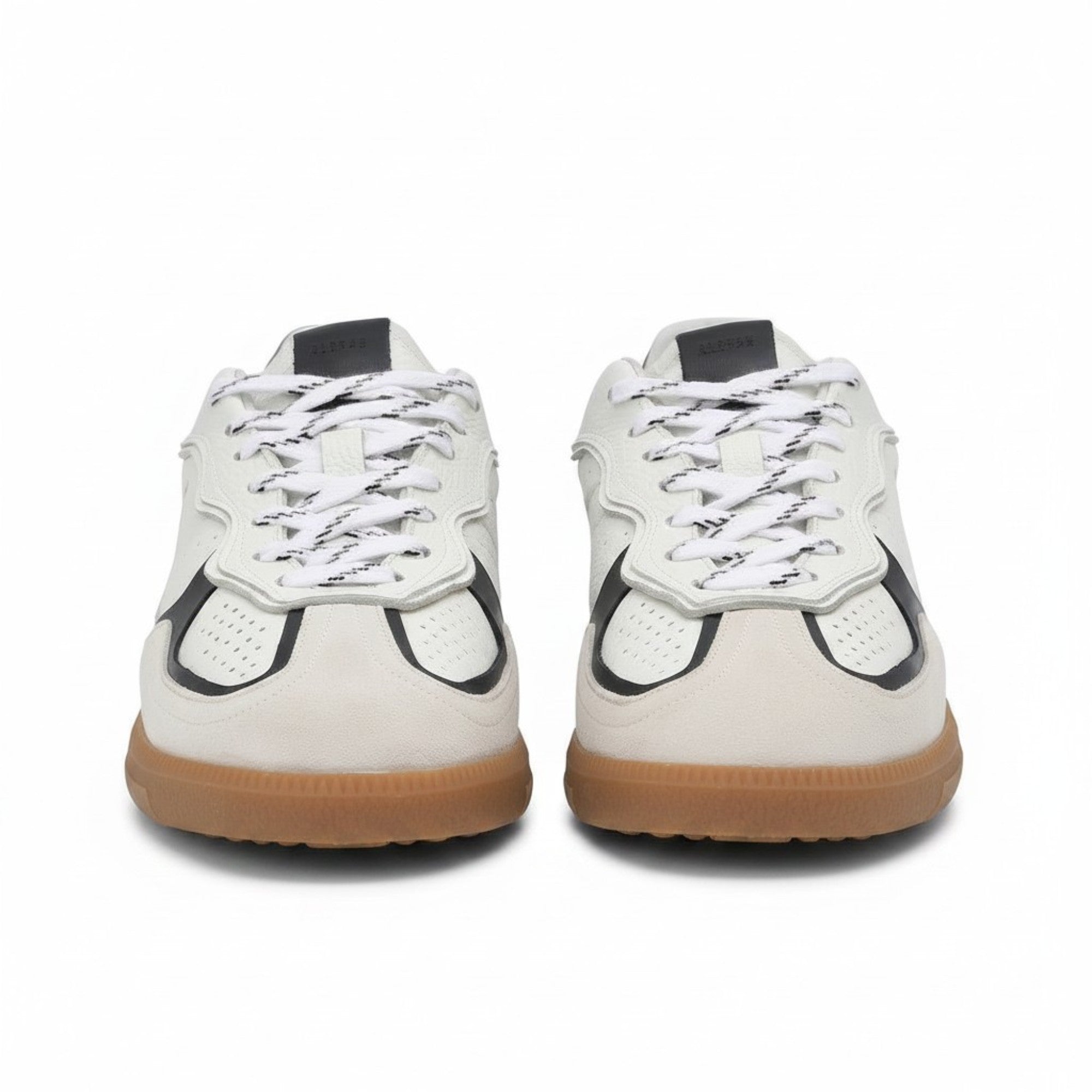 Front face-on view of a pair of ALOHAS white and burgundy lace-up sneakers highlighting the curved suede panels on the toe box.
