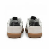 Rear heel view of a pair of ALOHAS sneakers showcasing the contrasting green leather heel tabs and the gum rubber sole border.
