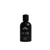 A matte black bottle of Secret Sun Memories Hand Cream with a matching black cap, standing upright on a light gray background.