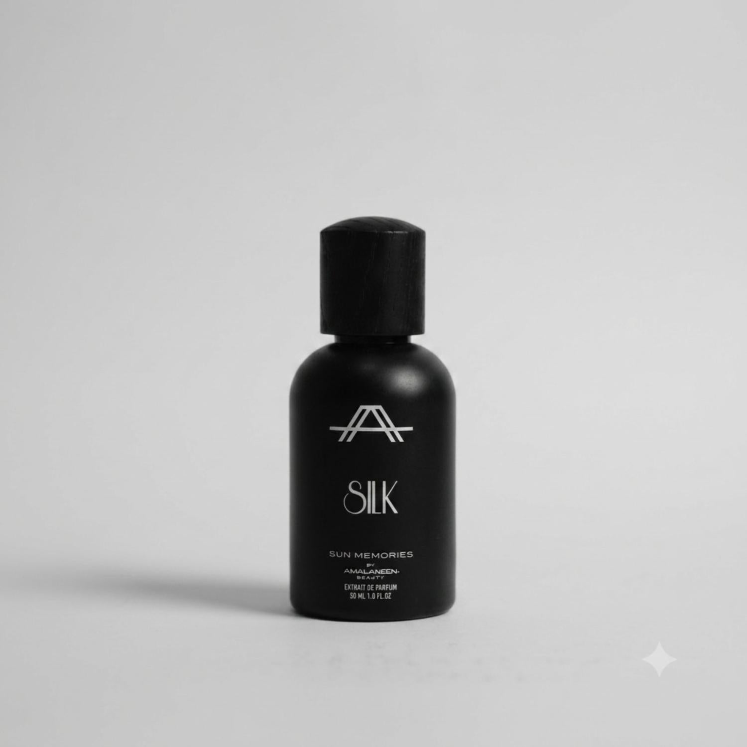 Front studio view of the luxury A Secret Sun Memories Silk 30ml Extrait De Parfum by Amal Ameen Beauty in a matte black bottle with a wooden cap, from the BLUE SALON shop.