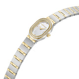 An angled perspective shot showcasing the slimness of the oval case, the polished gold-plated crown, and the fluid layout of the integrated two-tone stainless steel link bracelet.
