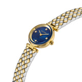 An angled close-up studio photograph of the Escada Scarlett timepiece, accentuating the thin round gold case, the bevelled crystal edge, the crown, and the fluid drape of the two-tone metallic scale band.