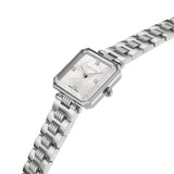 An angled perspective shot of the Escada Ava 22mm watch, emphasizing the faceted gemstone-cut bezel style, polished crown, and the fluid texture of the ribbed multi-link steel bracelet.