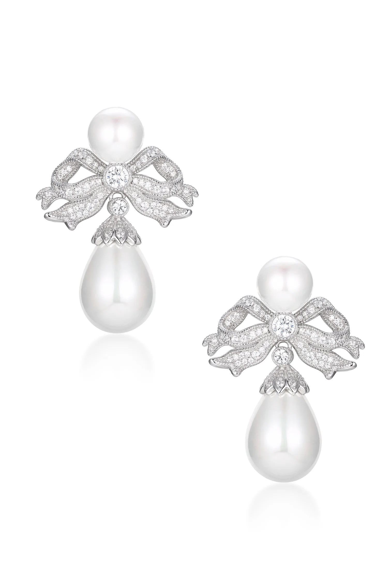 Pair of silver-toned bow and pearl drop earrings with clear stones and white pearls.