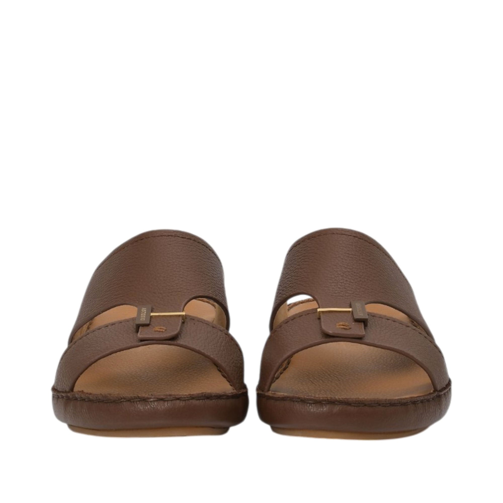 Front-facing view of a pair of Antonio brown leather sandals, highlighting the grained texture, central tab with a gold-finish metal bar accent, and open-toe design against a white background.