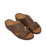 An overhead three-quarter angle view of a pair of Antonio brown grained leather Arabic sandals, showcasing their rich texture and structured heritage design against a white background.