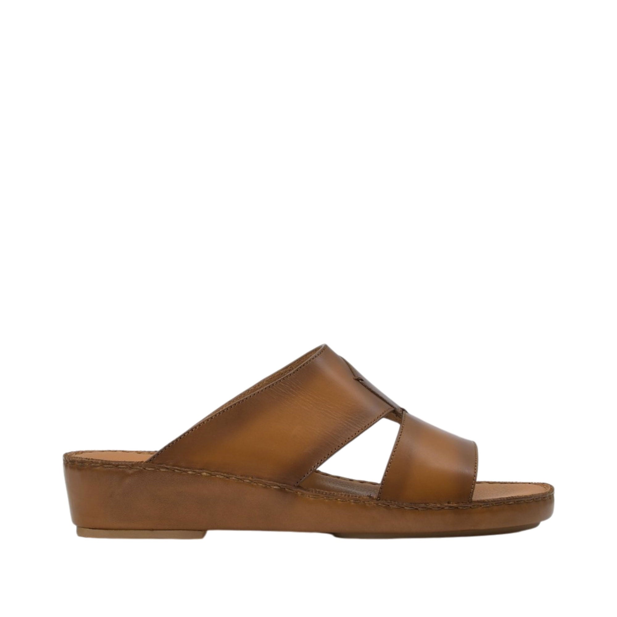 Profile view of an Antonio tan burnished leather Arabic sandal, showcasing its open-toe cross-strap upper and smooth leather-wrapped platform wedge sole against a white background.