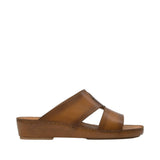 Profile view of an Antonio tan burnished leather Arabic sandal, showcasing its open-toe cross-strap upper and smooth leather-wrapped platform wedge sole against a white background.
