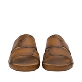 Front-facing view of a pair of Antonio tan leather sandals highlighting the symmetrical cross-strap design, artisanal accent stitching, and open-toe layout against a white background.