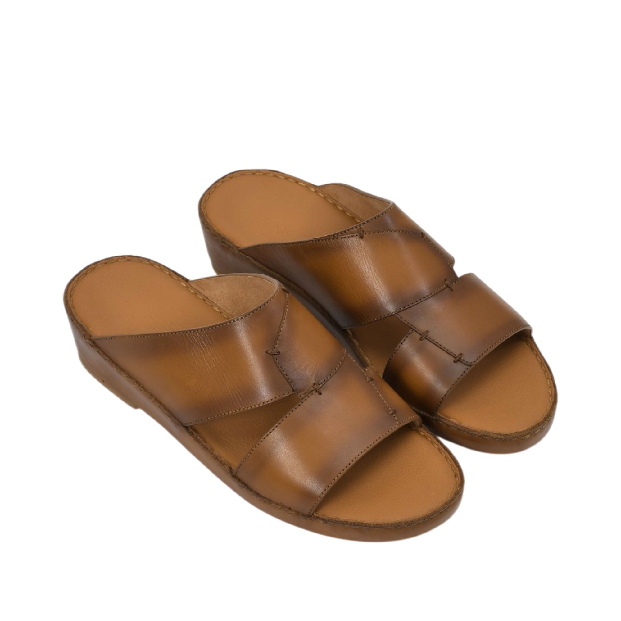 An overhead three-quarter angle view of a pair of Antonio tan leather Arabic sandals, illustrating their rich burnished finish and classic layered strap design against a white background.