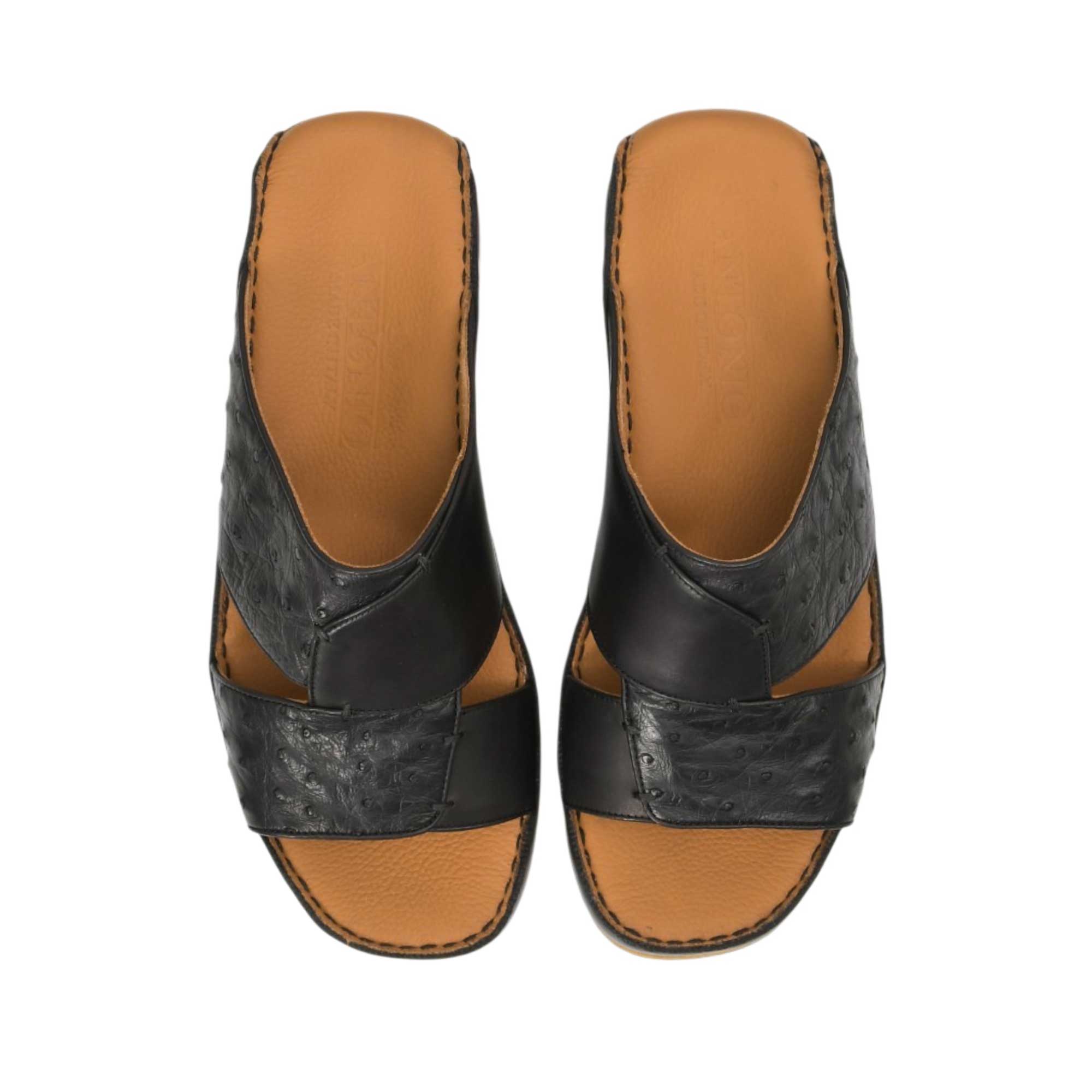 Direct top-down view of a pair of Antonio sandals showing the smooth tan leather insoles debossed with the Antonio logo and 'Made in Italy' emblem against a white background.