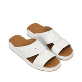 An overhead three-quarter angle view of a pair of Antonio white leather sandals, demonstrating the rich blend of smooth and ostrich-textured finishes against a white background.