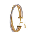 Three intertwined tubogas-style bands in silver-toned, gold-toned, and rose-gold-toned finishes, with a gold-toned clasp and