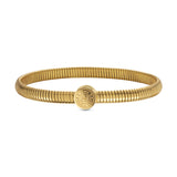 Gold-toned tubogas bangle with a central circular coin motif engraved with "SAINT HONORE PARIS" and an "S" logo.