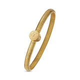 Gold-toned tubogas bangle with a central round coin motif featuring 'SAINT HONORE PARIS' text and an 'S' logo.