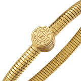 Gold-toned tubogas bangle with a central circular coin motif featuring 'SAINT HONORE PARIS' text and 'SH' logo.